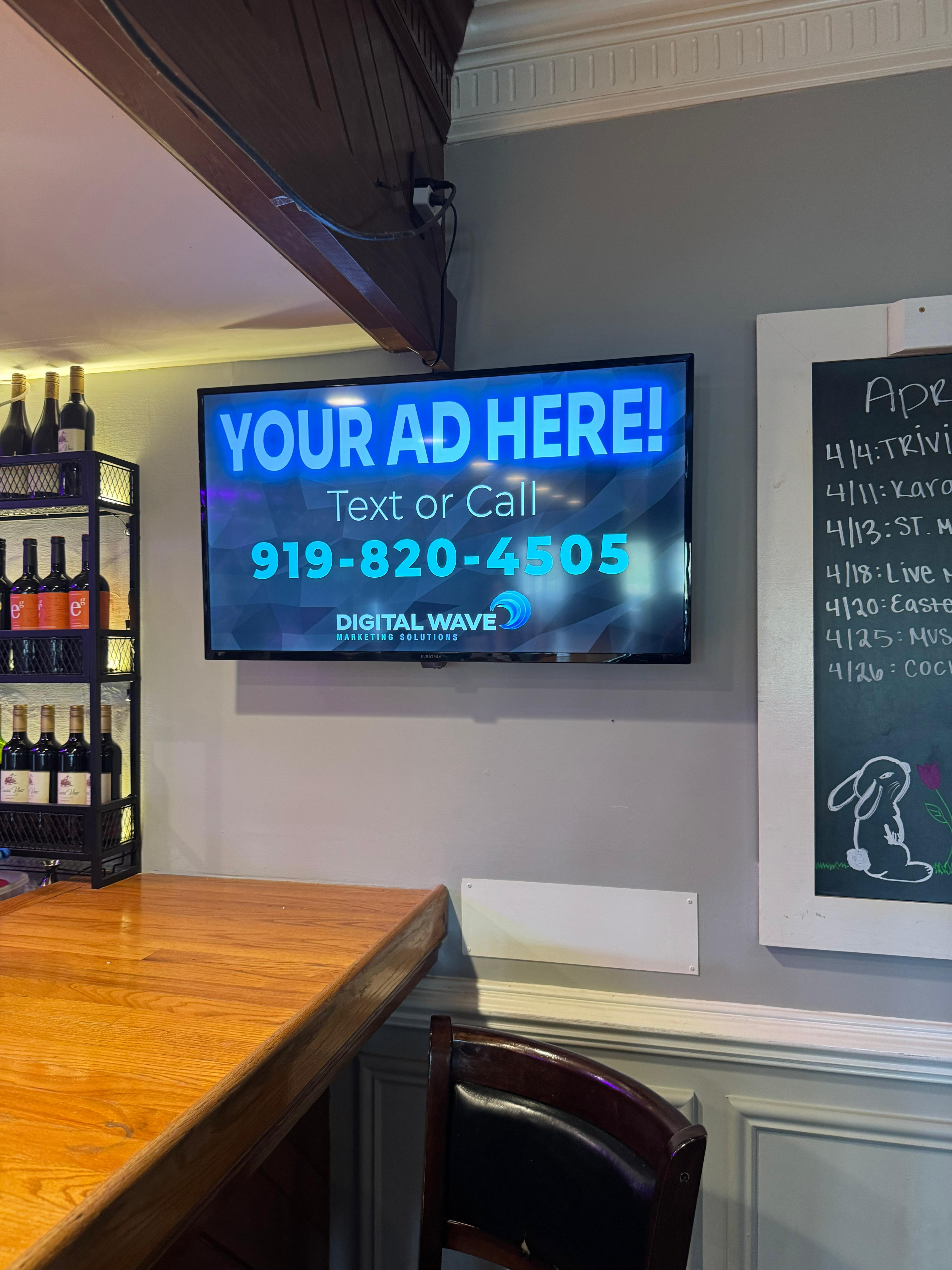 Indoor billboard advertisement displayed above a restaurant and bar area